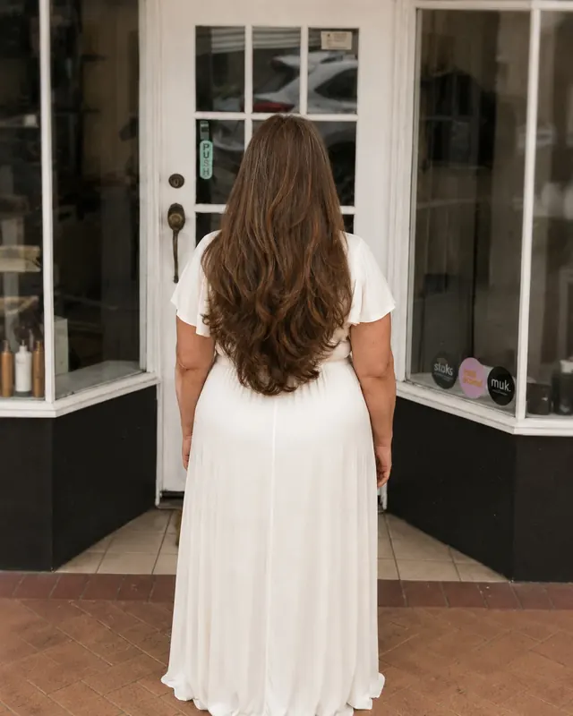 Long softly layered brunette hair viewed from behind